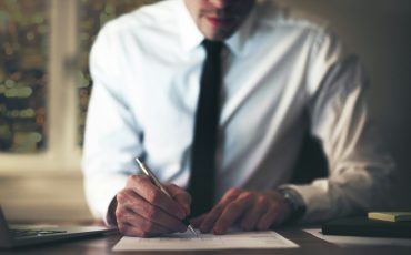 Businessman signing document